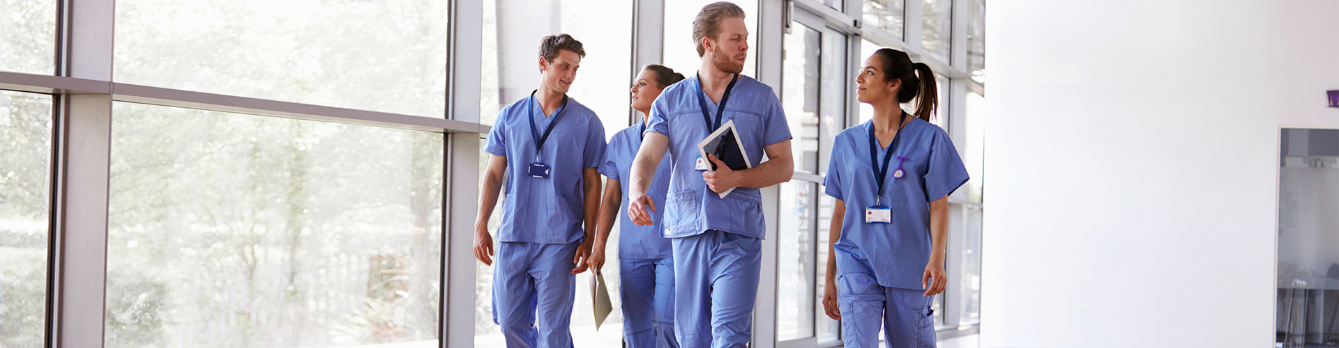 four healthcare staff smiling