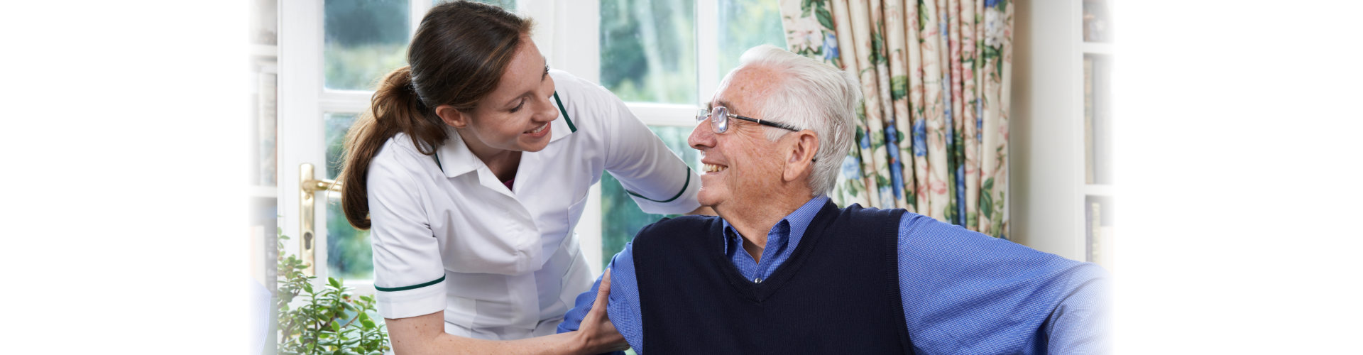 senior man assisted by the healthcare staff to stand