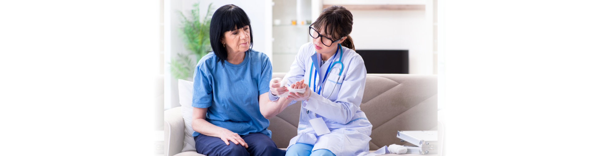 healthcare staff helping senior woman with her wounds